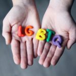 close up photo of lgbtq letters on a person s hands