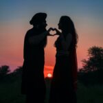 silhouette photo of couple making a heart shape
